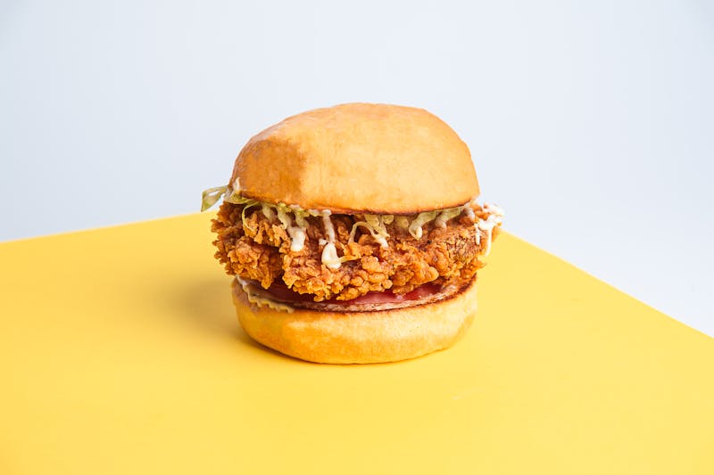 Crispy fried chicken burger with pickles and sauce